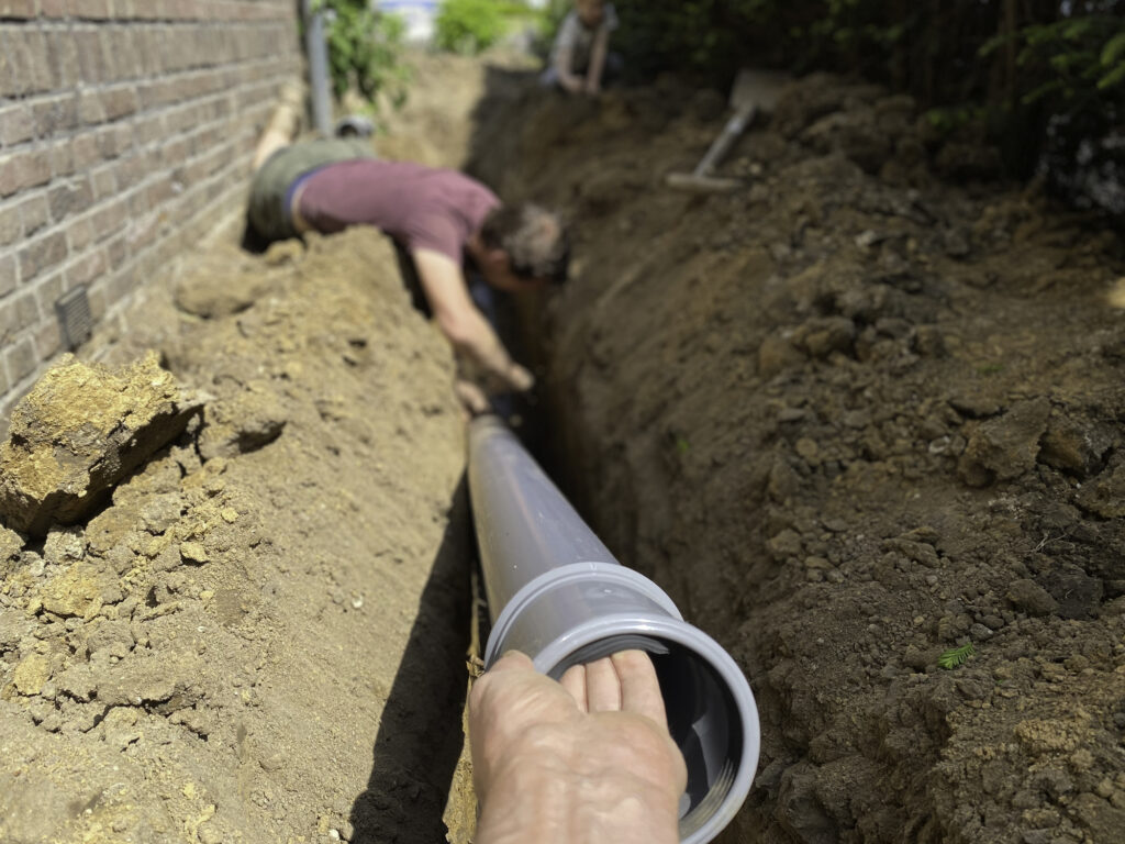 Two plumbers fixing a sewer line