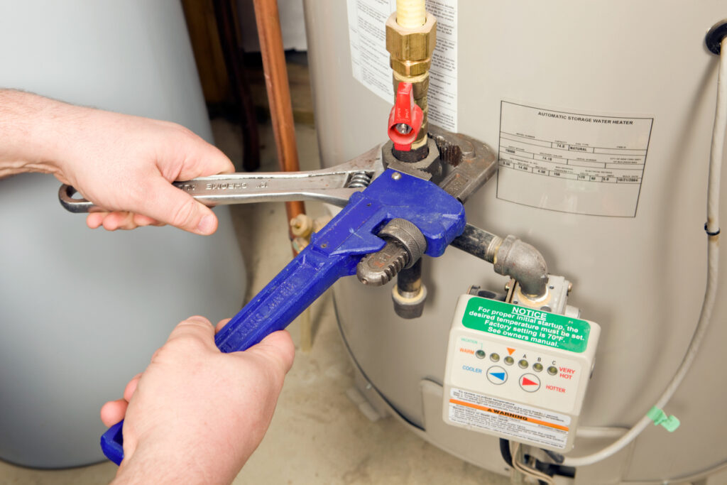 Plumber repairing a gas water heater