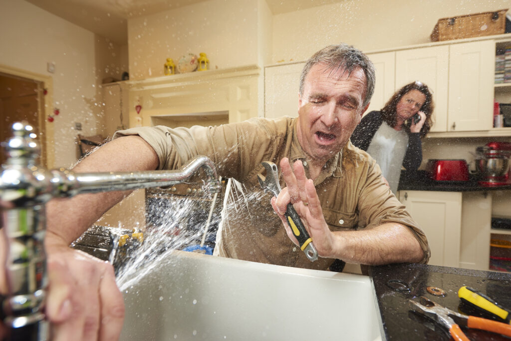 homeowner tried fixing the tap and wife is calling emergency plumber as water gushes from the broken tap